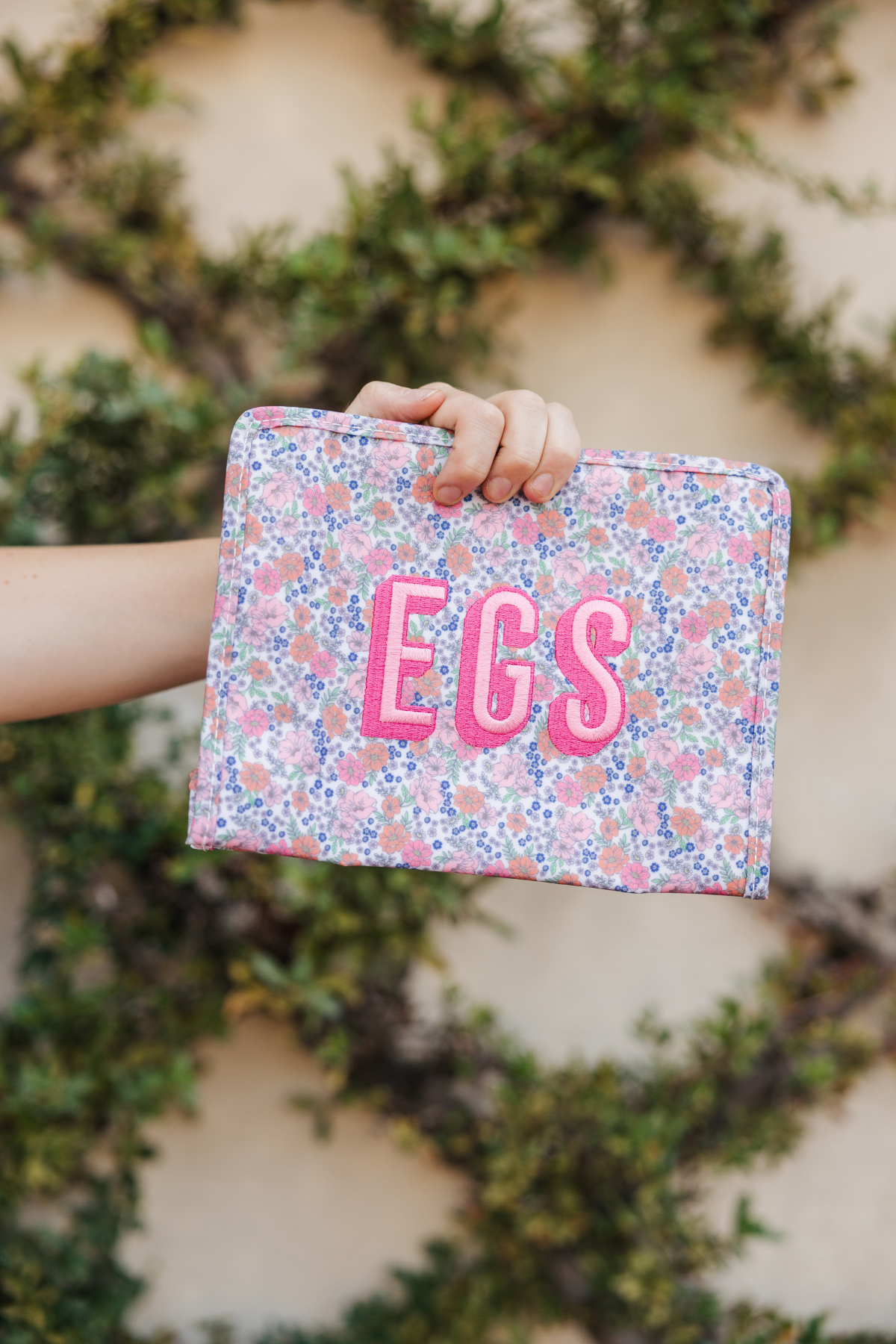 Floral pouch with 'EGS' monogram embroidered in pink.