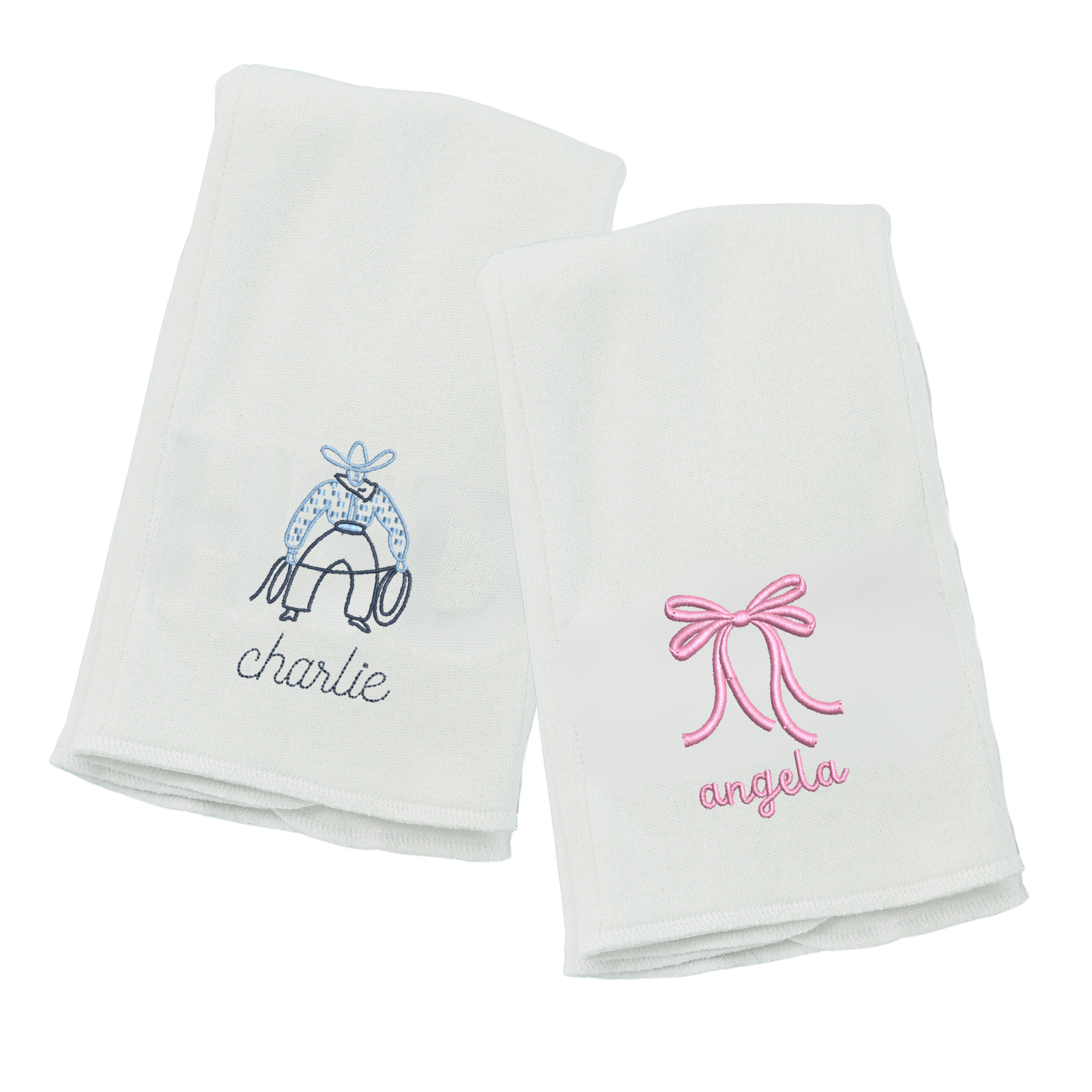 Two white personalized towels, one with a blue saddle design and the other with a pink bow design.