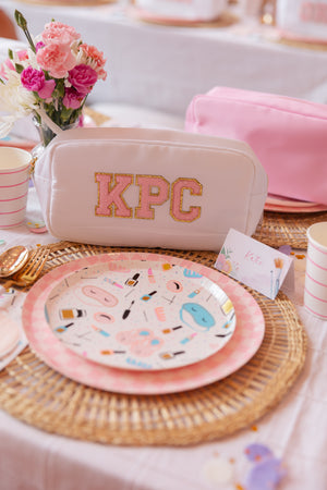 "White pouch featuring the initials 'KPC'