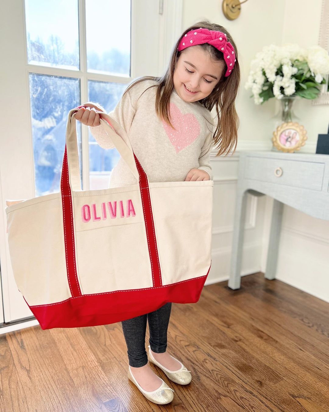 Large canvas tote bag with 'Olivia' in pink letters and red accents