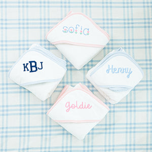 Four personalized hooded baby towels each with different embroidery