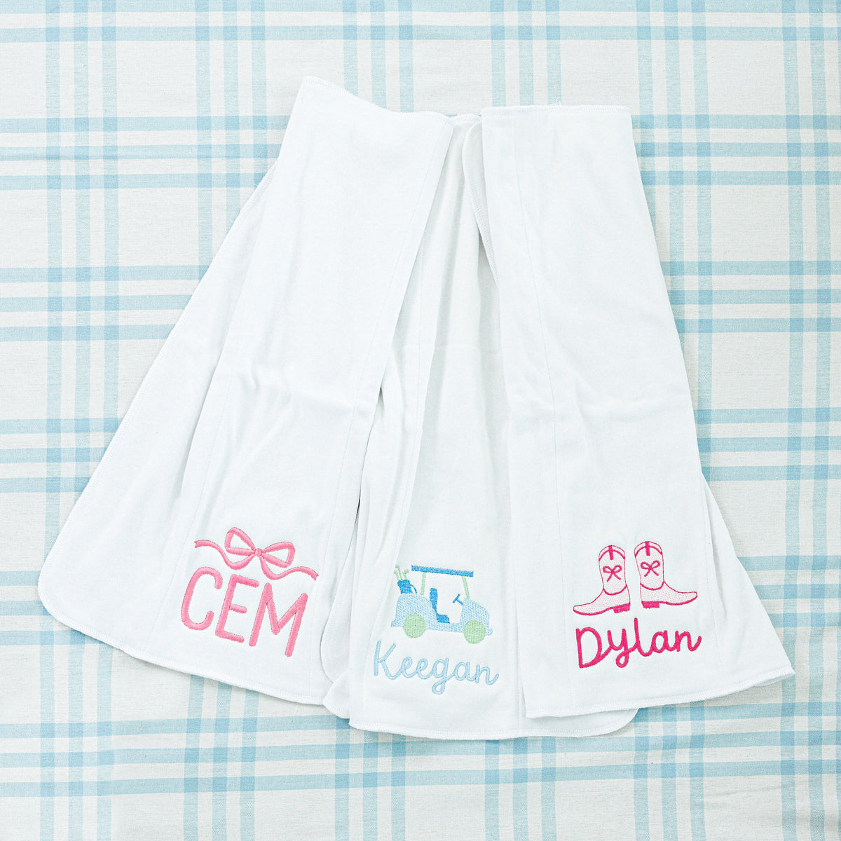 Three personalized baby towels. All with unqiue designs