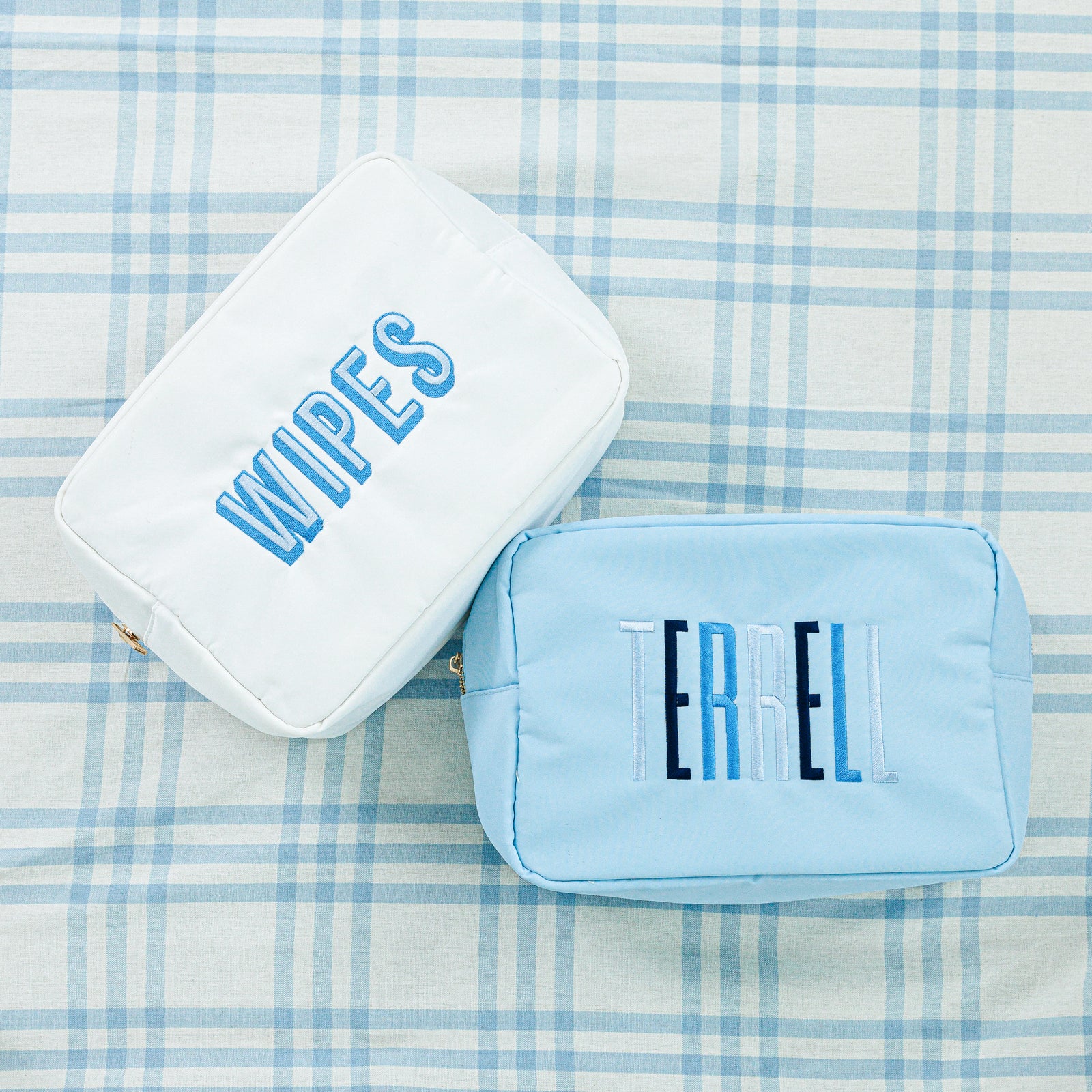 Three colorful pouches displayed: one in blue, one in white, and one in pink.