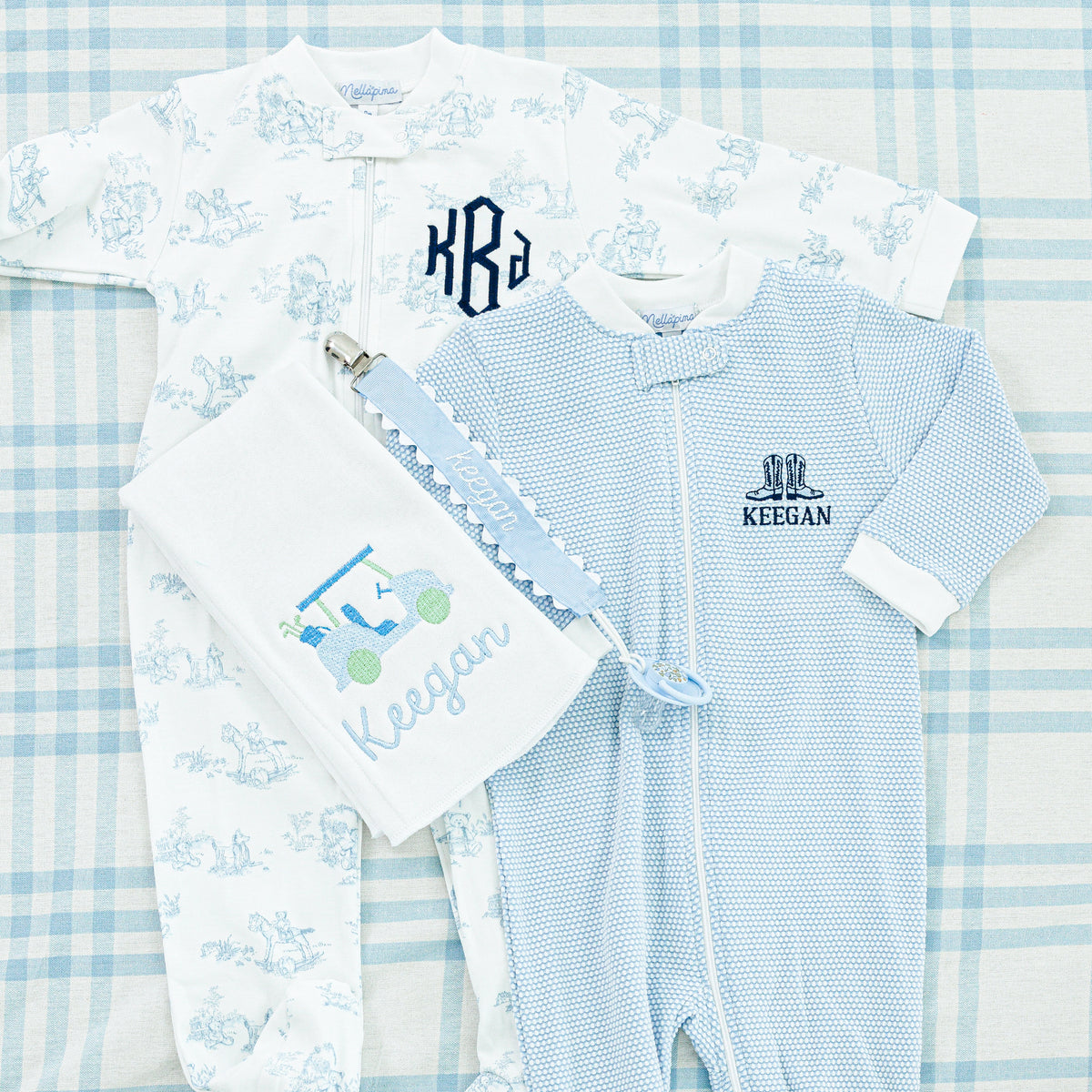 Personalized baby gift set featuring blue and white onesies,
