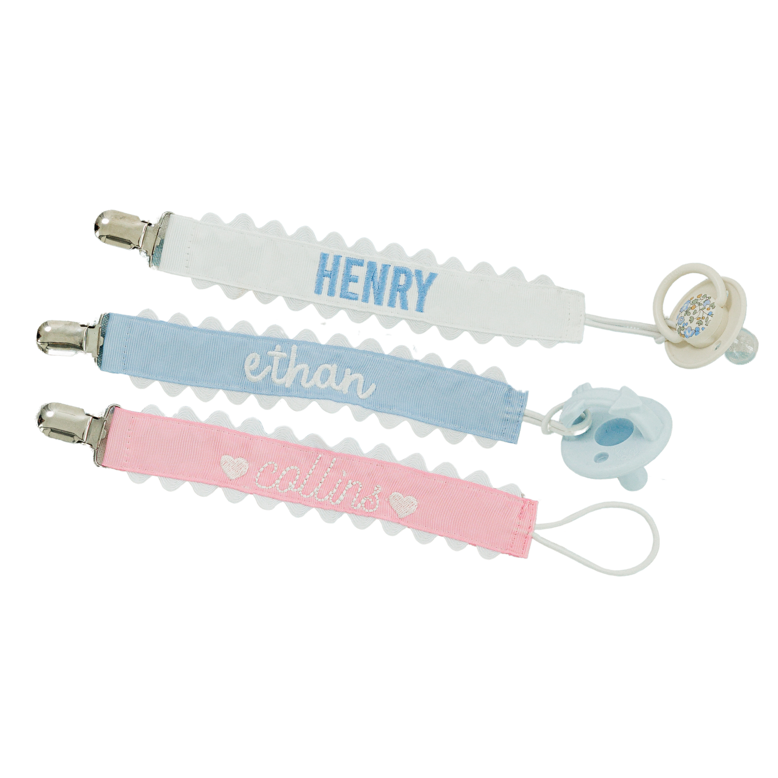 Set of three pastel-colored pacifier clips with rickrack trim.