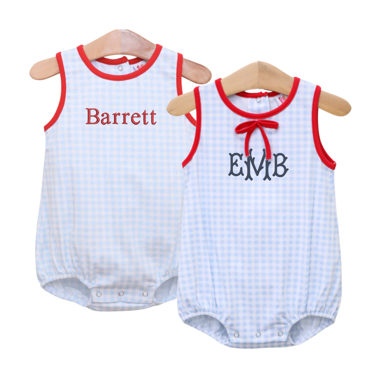 Two Blue & Red Gingham Bubbles displayed on wooden hangers. The sleeveless baby bubbles feature a light blue gingham print with bold red piping around the armholes and neckline. One style is accented with a red embroidered name "Barrett," while the other features a red bow detail and black monogram "EMB," making them perfect for coordinating sibling outfits with a patriotic or preppy twist.