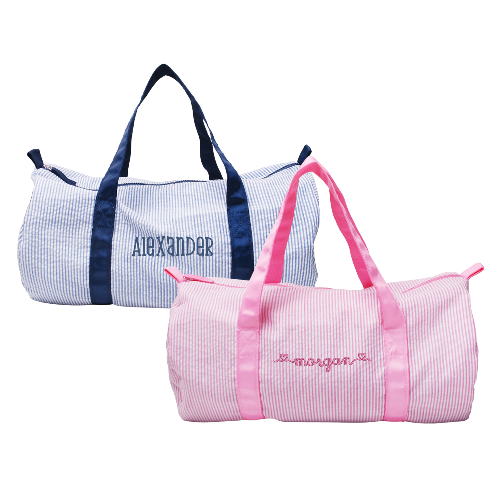 Two personalized duffel bags: a blue-striped bag with navy handles and a pink-striped bag with pink handles.