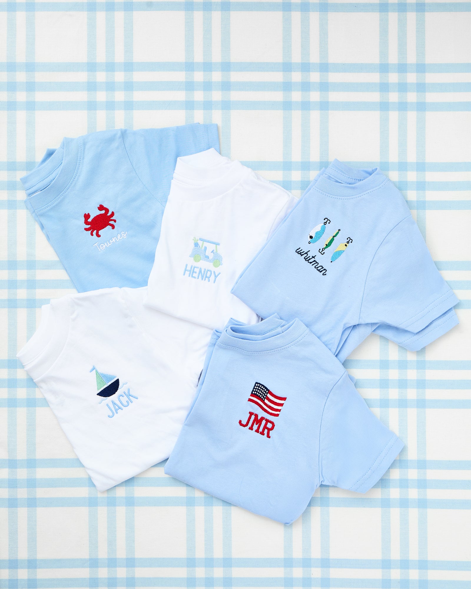 Solid Short Sleeve T-Shirts with Motif featuring playful personalization—blue tee with a red firetruck design and the name "BEN," and white tee with a pink unicorn motif and the name "ALI," perfect for everyday fun and comfort