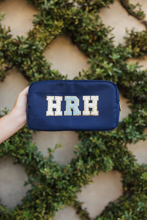Dark blue pouch featuring the initials 'HRH' in large, bold, patch-style letters 