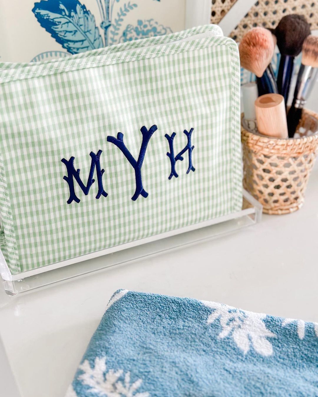 Green gingham pouch with 'MYH' monogram embroidered in navy.
